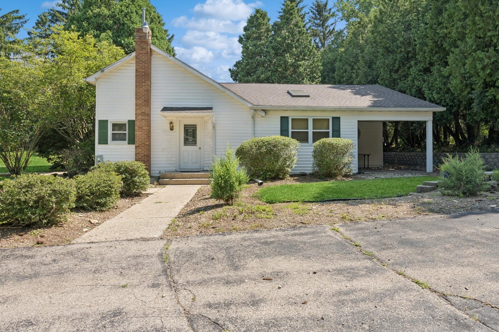 W1800 County Road B Bloomfield, WI 53128 - Photo 65 of 81 Charming ranch-style secondary residence with covered entry, mature landscaping, and private setting near the main drive.