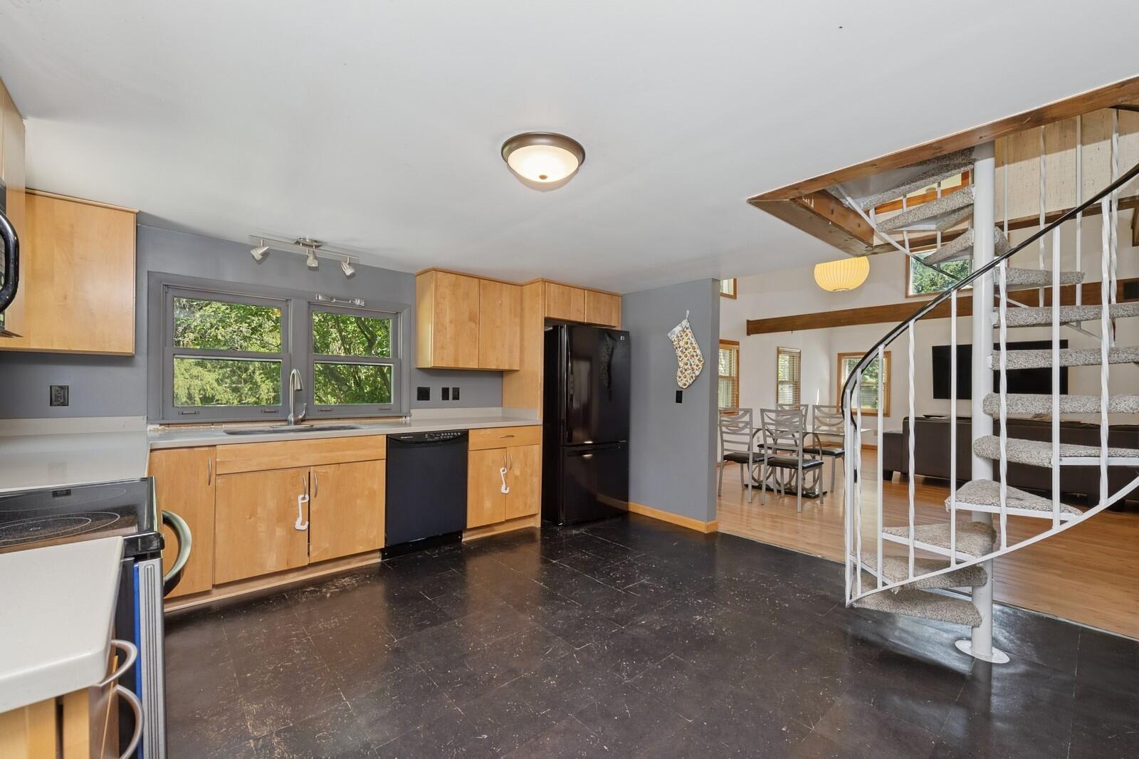 W1800 County Road B Bloomfield, WI 53128 - Photo 66 of 81 Functional kitchen with wood cabinetry, ample counter space, and an open connection to the main living and dining areas.