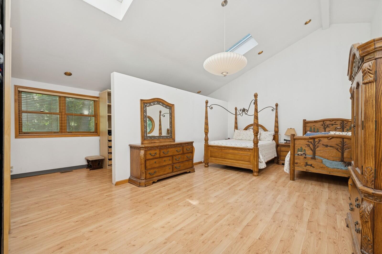W1800 County Road B Bloomfield, WI 53128 - Photo 70 of 81 Spacious bedroom featuring hardwood flooring, skylights, and ample wall space, creating a comfortable and light-filled retreat.