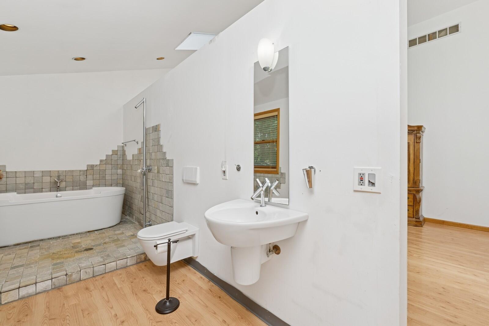 W1800 County Road B Bloomfield, WI 53128 - Photo 71 of 81 Modern bathroom with pedestal sink, tiled flooring, and a clean, functional layout with natural light.