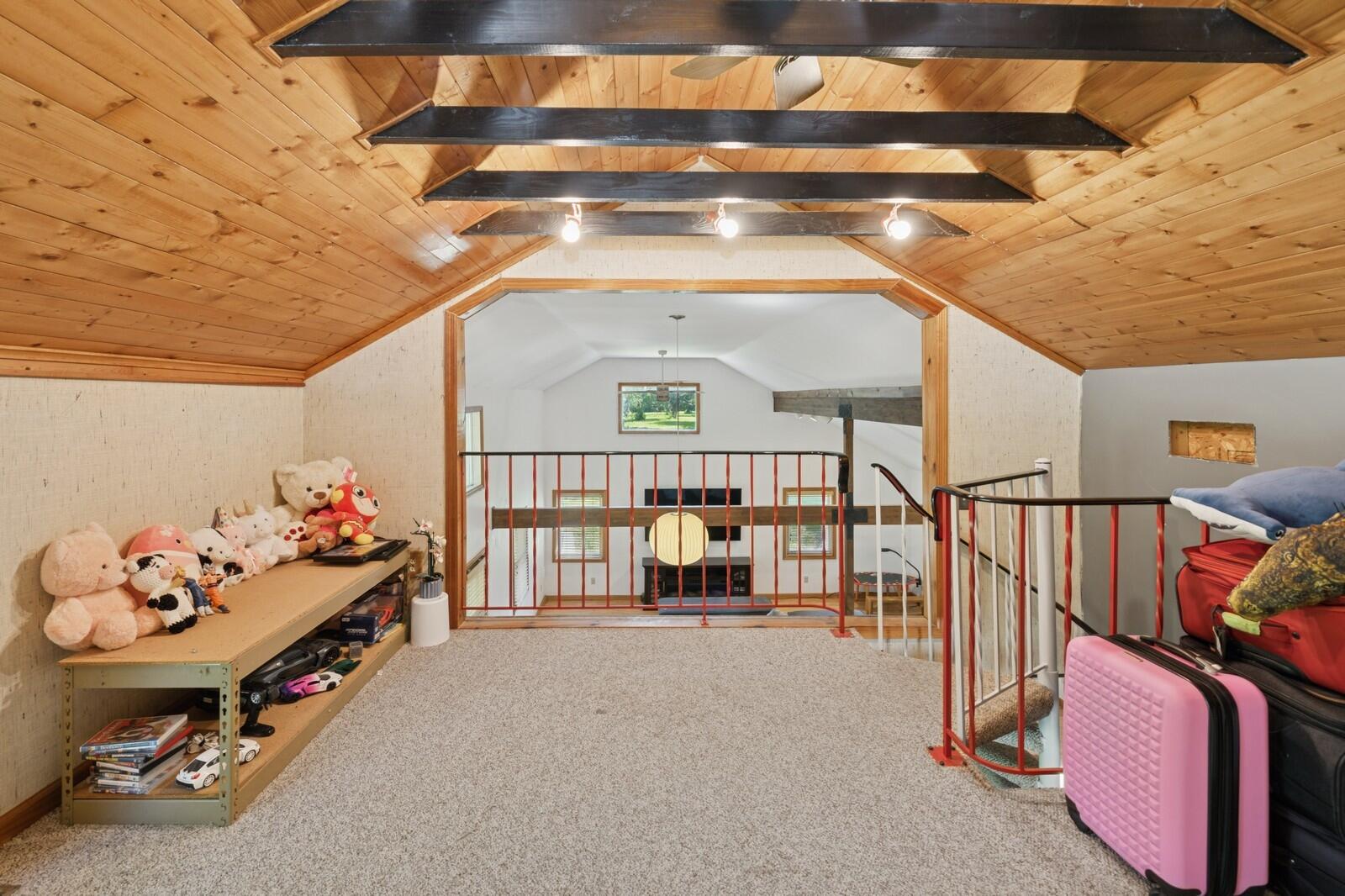 W1800 County Road B Bloomfield, WI 53128 - Photo 74 of 81 Open loft overlooking the main living space, featuring wood ceiling details and flexible use for office, lounge, or play area.
