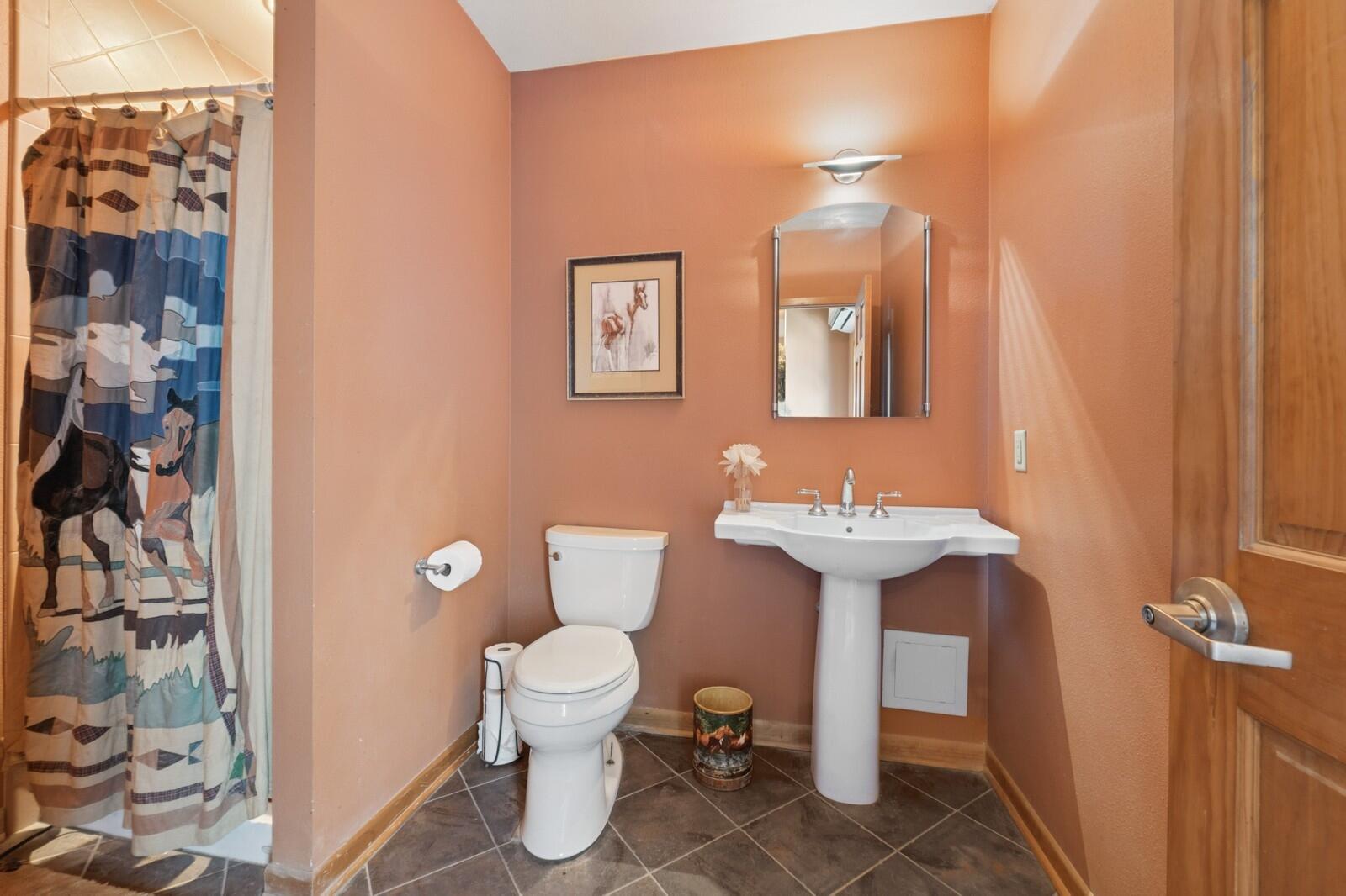 W1800 County Road B Bloomfield, WI 53128 - Photo 10 of 81 Convenient on-site bathroom with tiled flooring and walk-in shower, located within the equestrian facility.