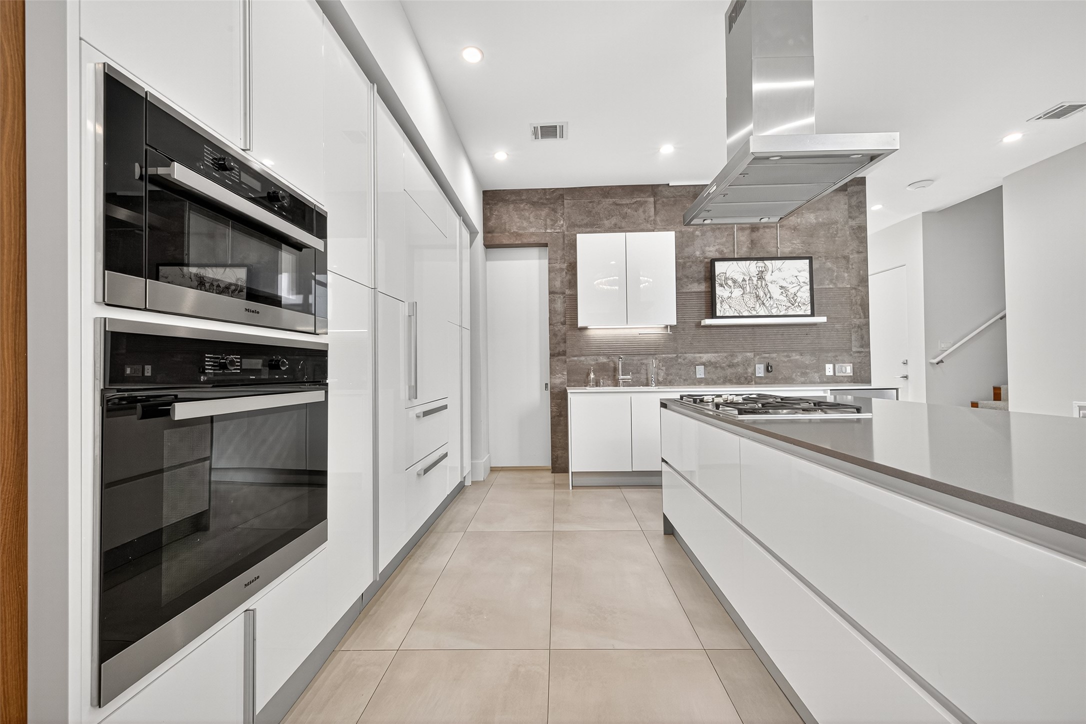 211 Stratford Street Houston, TX 77006 - Photo 6 of 33 a kitchen with stainless steel appliances and white cabinets