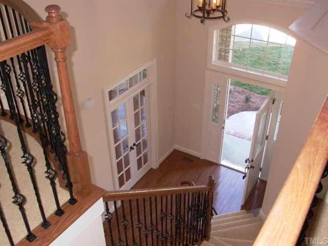 2204 Clayette Court Raleigh, NC 27612 - Photo 2 of 10 Elegant two story foyer. See study or formal livingroom at left of this picture. Staircase has wood handrails and wrought iron spindles w/open end treads and juliette balcony overlooking the entry.