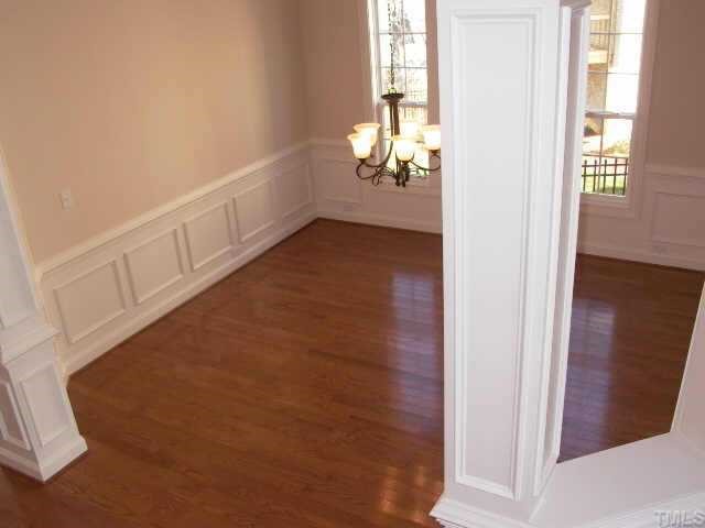 2204 Clayette Court Raleigh, NC 27612 - Photo 3 of 10 Beautiful separate dining room. Upgrade lighting, trey ceiling w/medallion, crown moulding, two columns, chair rail and picture framing. Built in glazed maple cabinetry, wet bar is diagonally left of dining room.