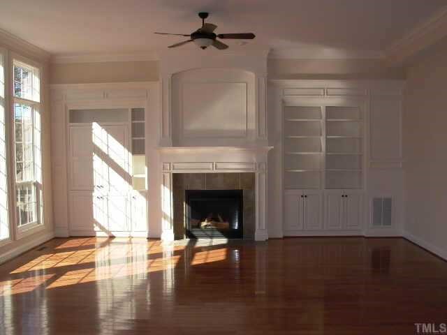 2204 Clayette Court Raleigh, NC 27612 - Photo 4 of 10 Huge functional family room. Well crafted built ins of media niche and bookcase flank the direct vent fireplace. Floor to ceiling windows on rear over looks the beautiful outdoor living space.