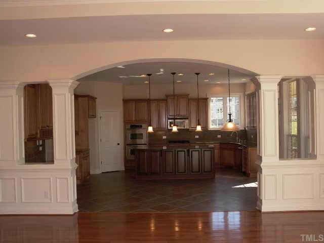 2204 Clayette Court Raleigh, NC 27612 - Photo 5 of 10 Outstanding Chefs kitchen is open to family room. Cabinets are glazed Maple, granite tops, SS appliances, walk in pantry next to full double ovens, lights under cabinets. Breakfast area leads to screened porch over looking stone patio