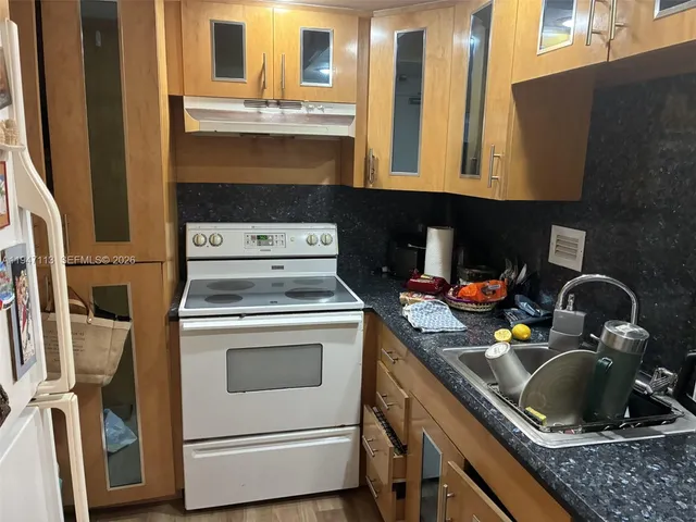 a bed sitting in a bedroom next to a lamp