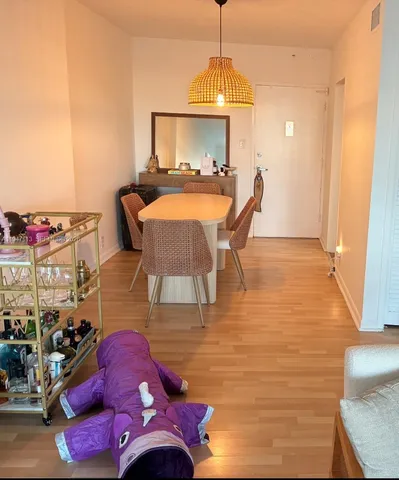 a living room with furniture chess board and a window