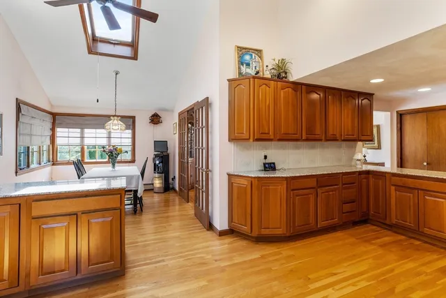 a large kitchen with stainless steel appliances granite countertop a stove a sink dishwasher and a refrigerator