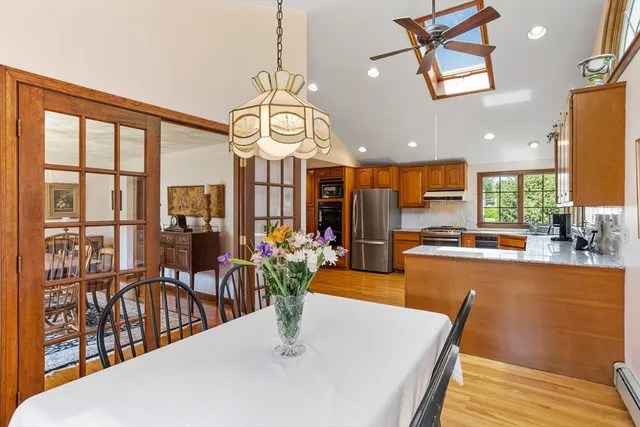 a view of a dining room with furniture a chandelier and wooden floor