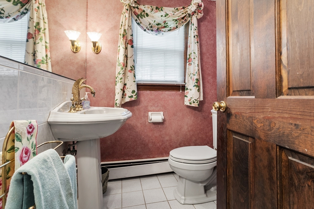40 Saw Mill Road Stow, MA 01775 - Photo 22 of 42 a bathroom with a sink a toilet and shower curtain