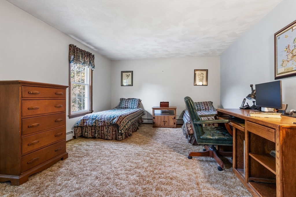 40 Saw Mill Road Stow, MA 01775 - Photo 29 of 42 a bedroom with a bed and a desk