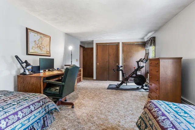 a bedroom with furniture and a lamp