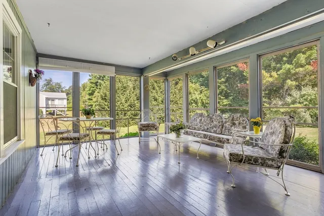 a living room filled with furniture and a large window