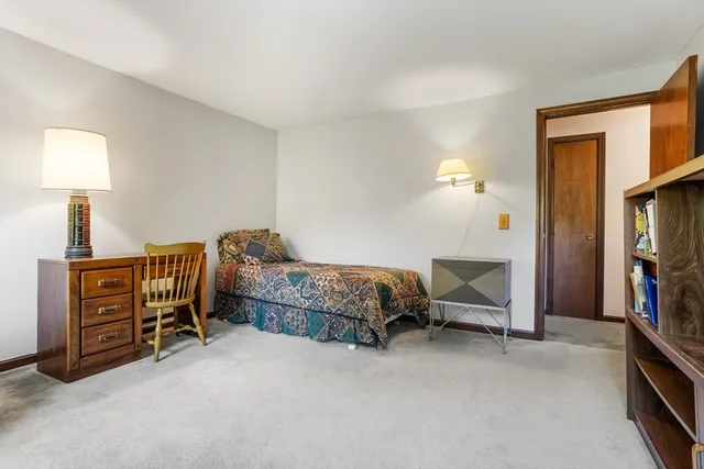 a bedroom with furniture and a window