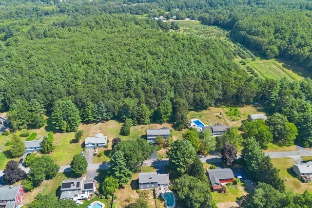 an aerial view of a house with a yard basket ball court and outdoor seating