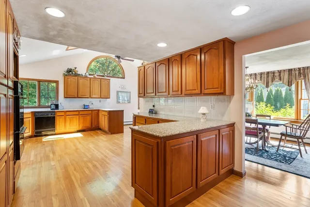 a kitchen with a sink cabinets and wooden floor