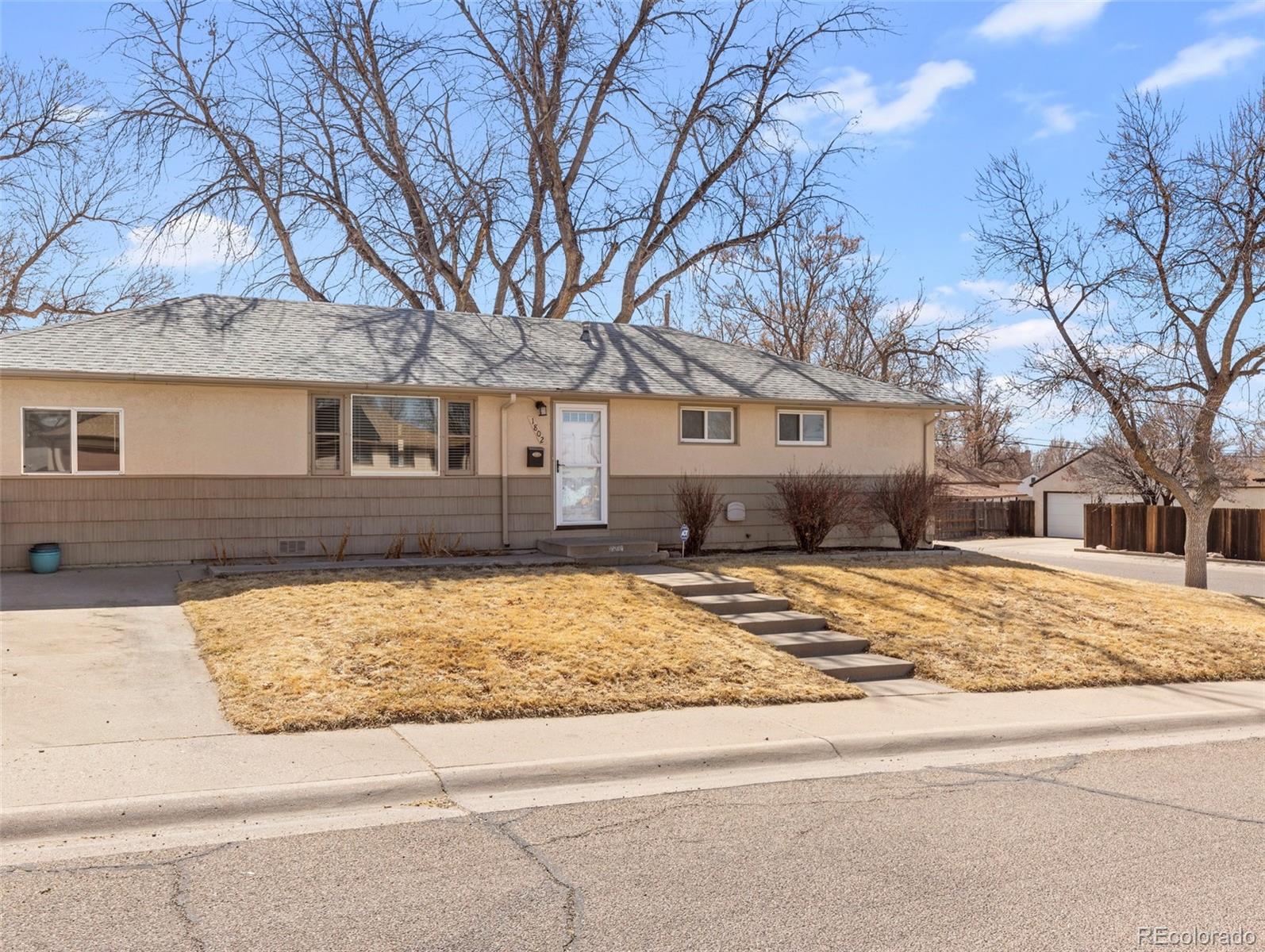 1802 Comanche Road Pueblo, CO 81001 - Photo 25 of 25 a front view of a house with a yard covered with snow