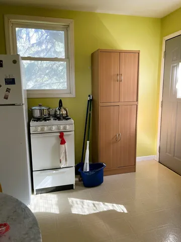 a bathroom with a sink a toilet and a shower curtain
