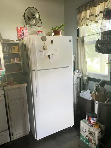 a white refrigerator freezer sitting inside of a kitchen