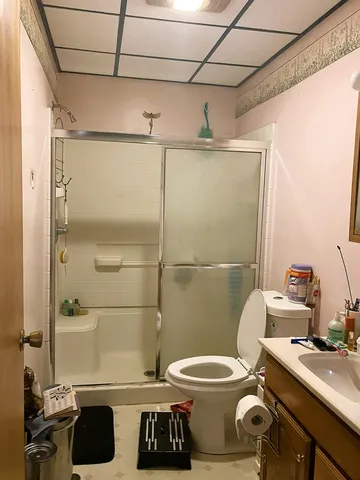a bathroom with a sink toilet and shower