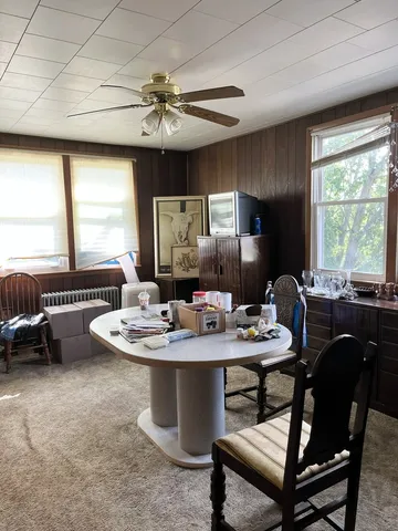 a dining room with furniture a window and a chandelier