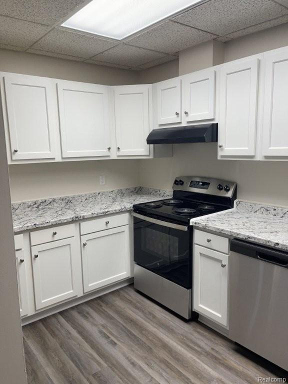 35775 Union Lake Road Clinton Township, MI 48035 - Photo 23 of 30 Kitchen with a drop ceiling, appliances with stainless steel finishes, white cabinetry, light wood finished floors, and under cabinet range hood