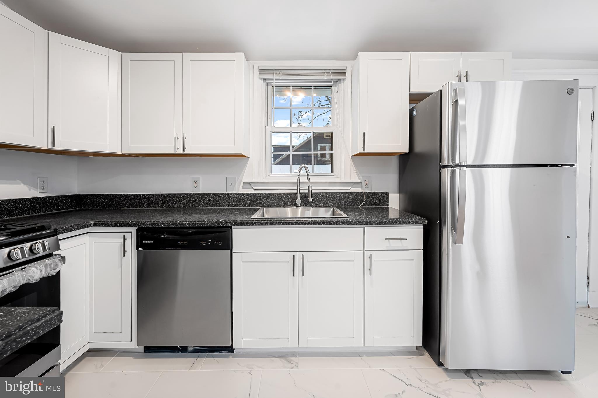 709 Elmwood Road Baltimore, MD 21206 - Photo 18 of 39 a kitchen with stainless steel appliances granite countertop a refrigerator a stove a sink and a granite counter tops