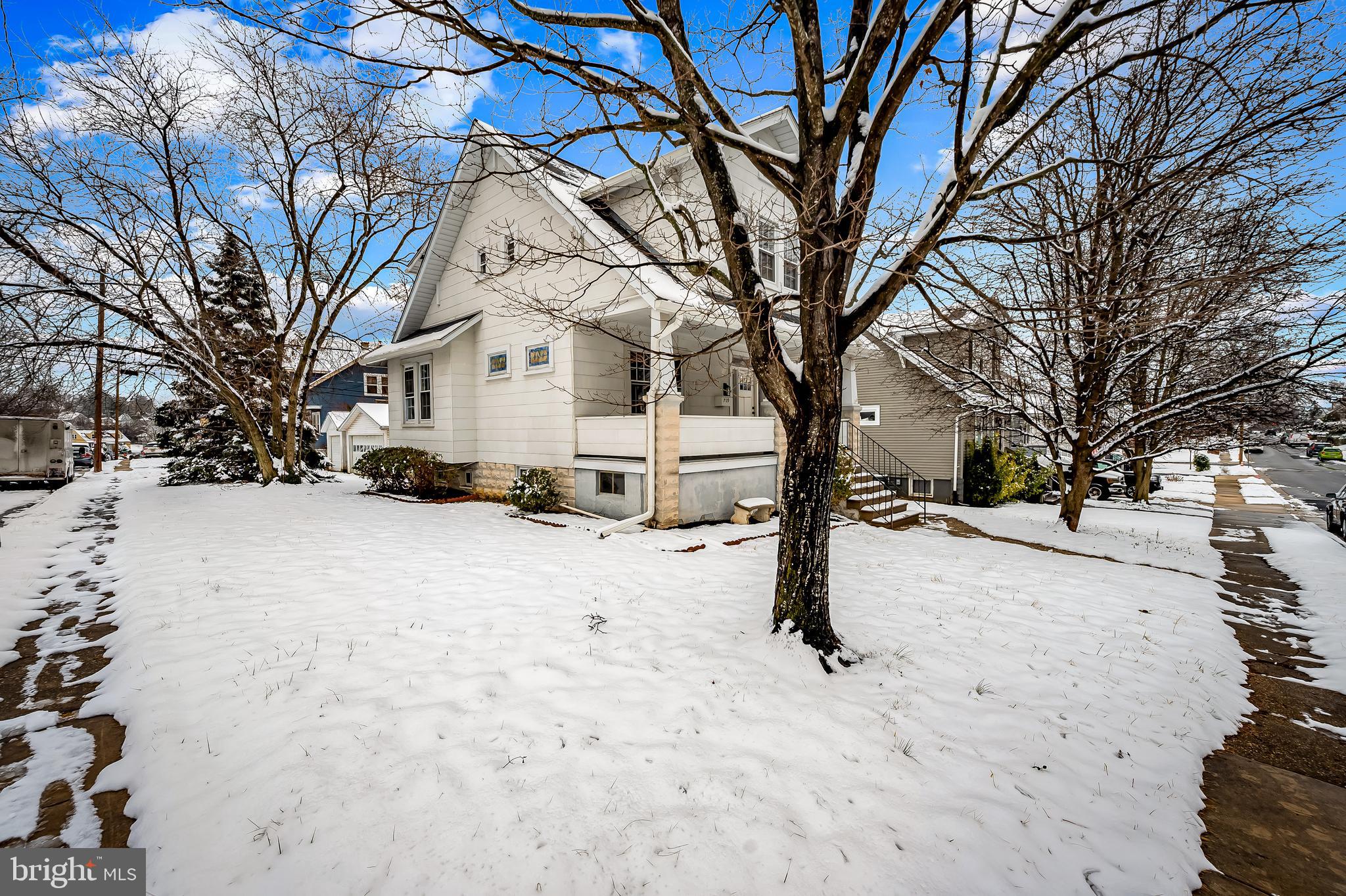 709 Elmwood Road Baltimore, MD 21206 - Photo 2 of 39 a street view covered with snow in front of house