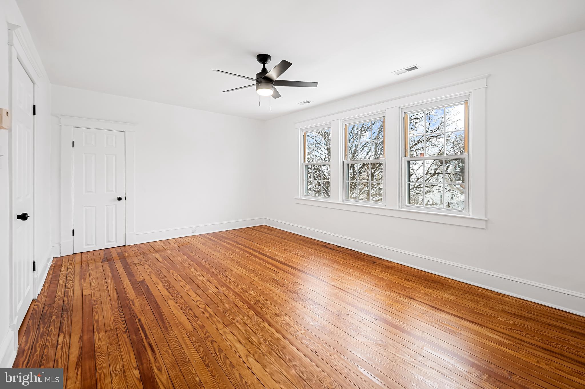 709 Elmwood Road Baltimore, MD 21206 - Photo 24 of 39 a view of empty room with wooden floor and fan