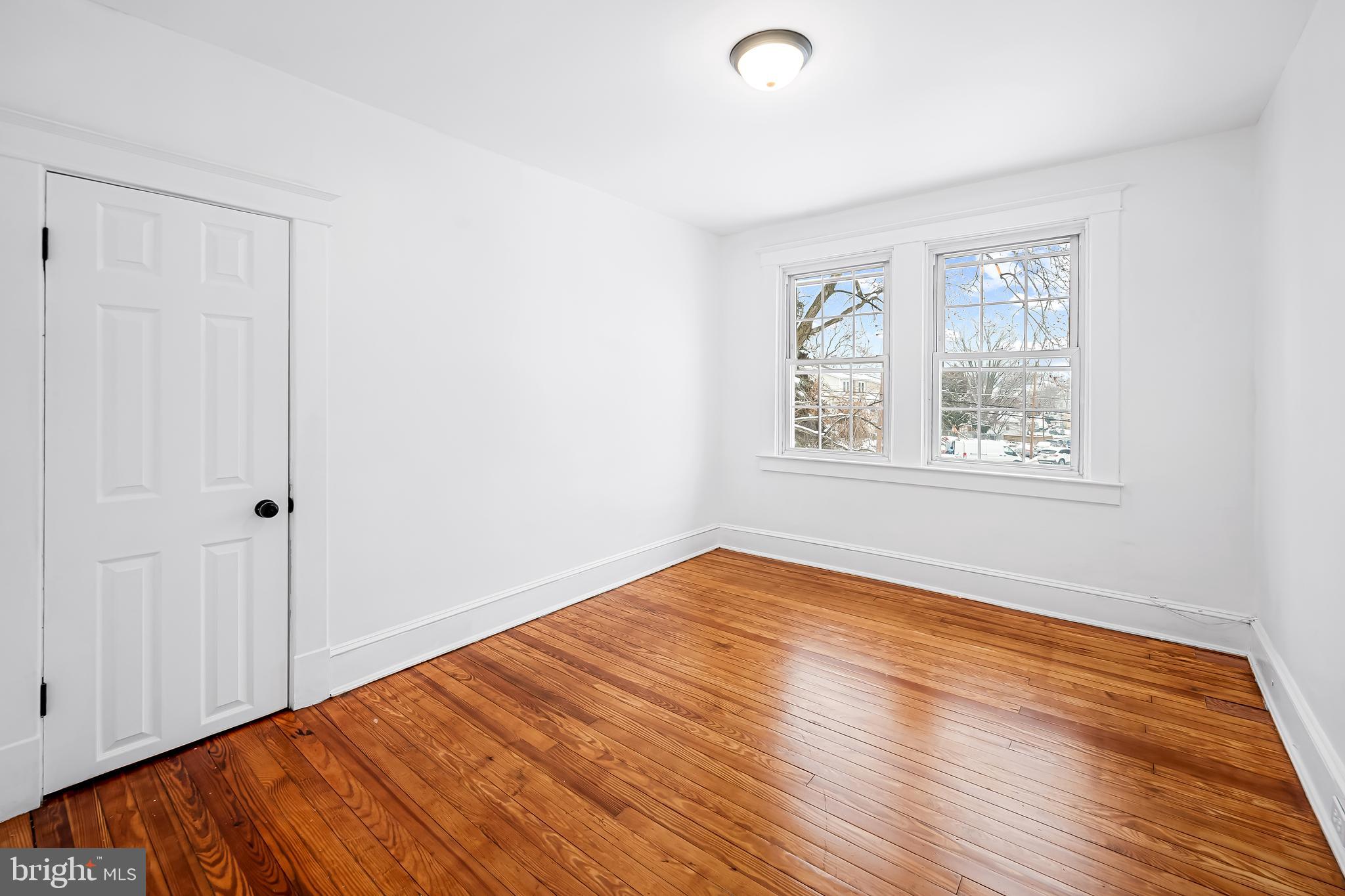 709 Elmwood Road Baltimore, MD 21206 - Photo 28 of 39 a view of an empty room with wooden floor and a window