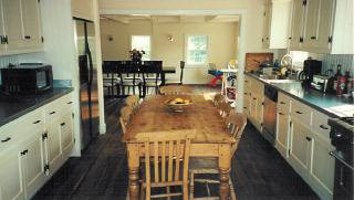 Turkey Hill Road, Unit 1135 Red Hook, NY 12571 - Photo 2 of 7 a kitchen with stainless steel appliances granite countertop a stove top oven a sink a dining table and chairs with wooden floor