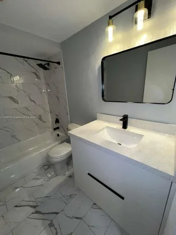 a bathroom with a sink a toilet and a bathtub