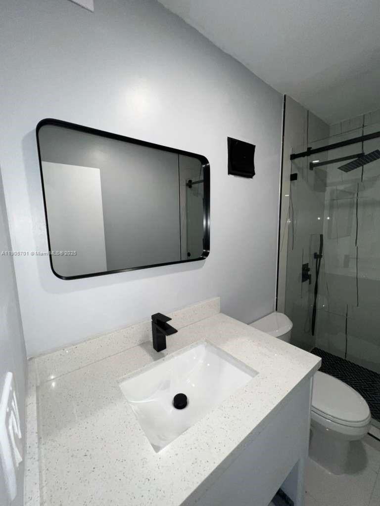 1799 Southwest 81st Terrace, Unit 135 Davie, FL 33324 - Photo 16 of 19 a bathroom with a sink a toilet and shower