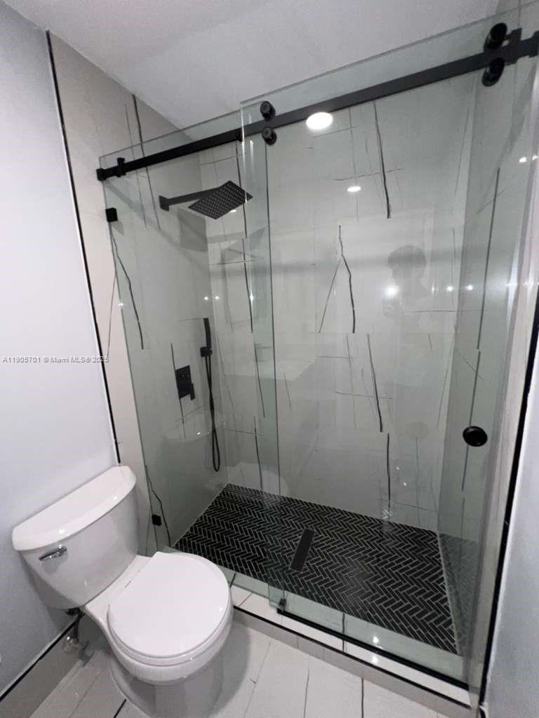 1799 Southwest 81st Terrace, Unit 135 Davie, FL 33324 - Photo 17 of 19 a bathroom with a toilet and a shower