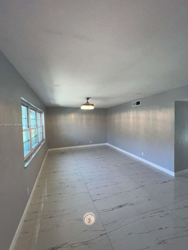 1799 Southwest 81st Terrace, Unit 135 Davie, FL 33324 - Photo 2 of 19 an empty room with windows and pillars in it