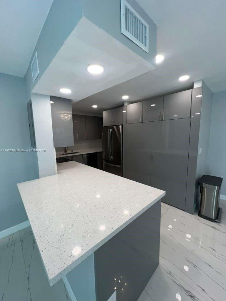 1799 Southwest 81st Terrace, Unit 135 Davie, FL 33324 - Photo 4 of 19 a large space with stainless steel appliances a refrigerator and a kitchen countertops