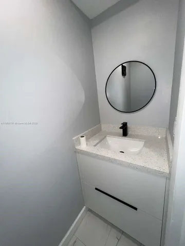 a bathroom with a sink and mirror