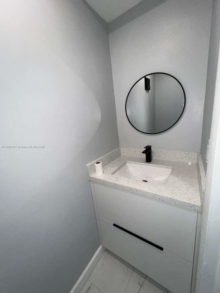 1799 Southwest 81st Terrace, Unit 135 Davie, FL 33324 - Photo 7 of 19 a bathroom with a sink and mirror