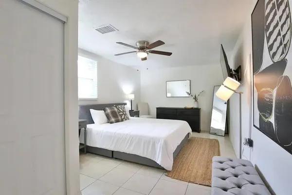 a bedroom with a bed and a chandelier
