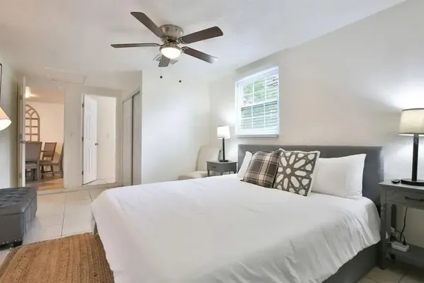 a bedroom with a large bed and a chandelier