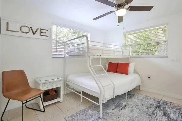 a bedroom with a bed and a chair