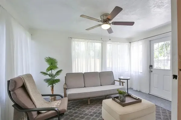 a living room with furniture and a potted plant
