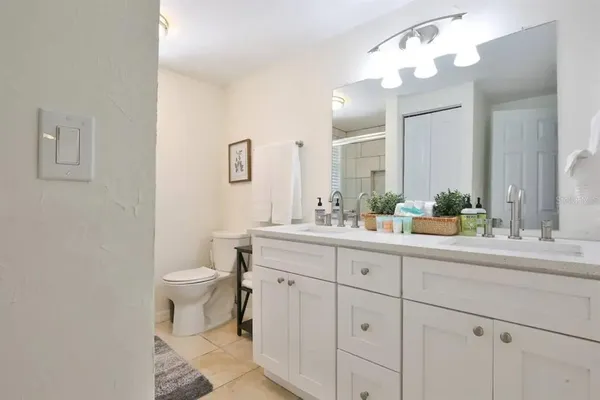 a bathroom with a sink a toilet and a mirror