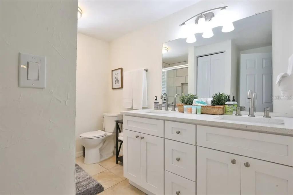 5622 South Lockwood Ridge Road Sarasota, FL 34231 - Photo 24 of 26 a bathroom with a sink a toilet and a mirror