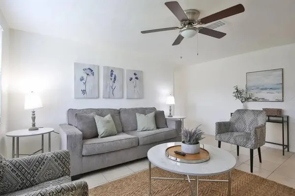 a living room with furniture and a wooden floor