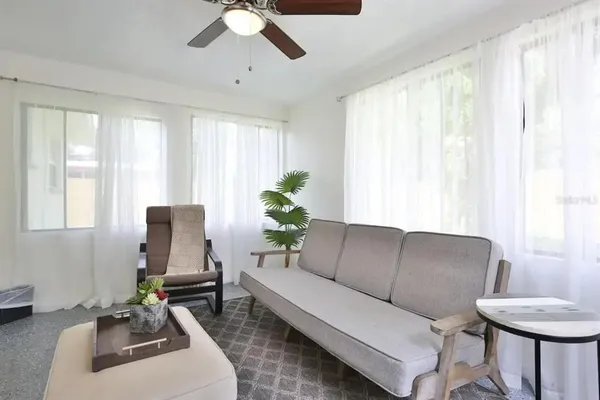 a living room with furniture and a large window