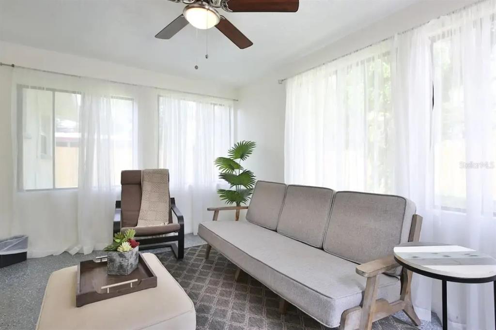 5622 South Lockwood Ridge Road Sarasota, FL 34231 - Photo 8 of 26 a living room with furniture and a large window