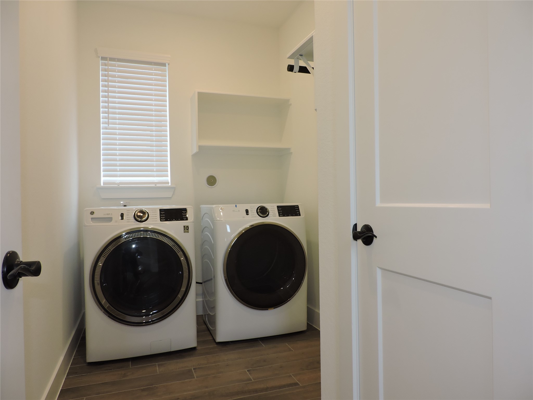 12853 Meadow Wind Way Conroe, TX 77302 - Photo 8 of 47 Spacious laundry with built-in clothes hanging bar and storage shelf's, Brand New Washer and Dryer included! Additional storage closet inside the room.